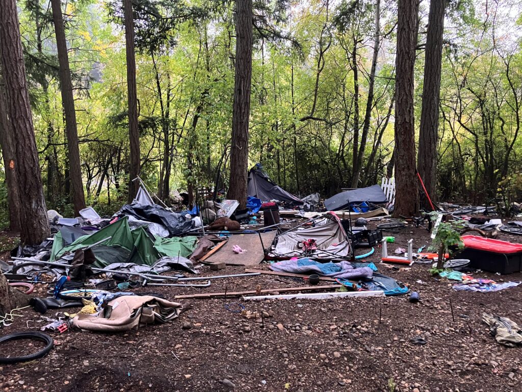 trash left behind at illegal encampment